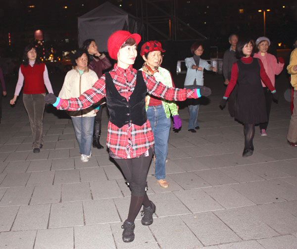 民眾踏著輕鬆的步伐，在夜晚的文化中心廣場裡翩翩起舞。(圖/ Anita 攝)